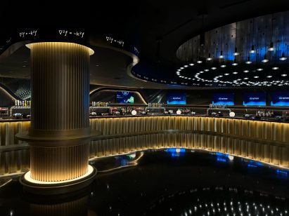 Dark bar area with gold-lit counter and column
