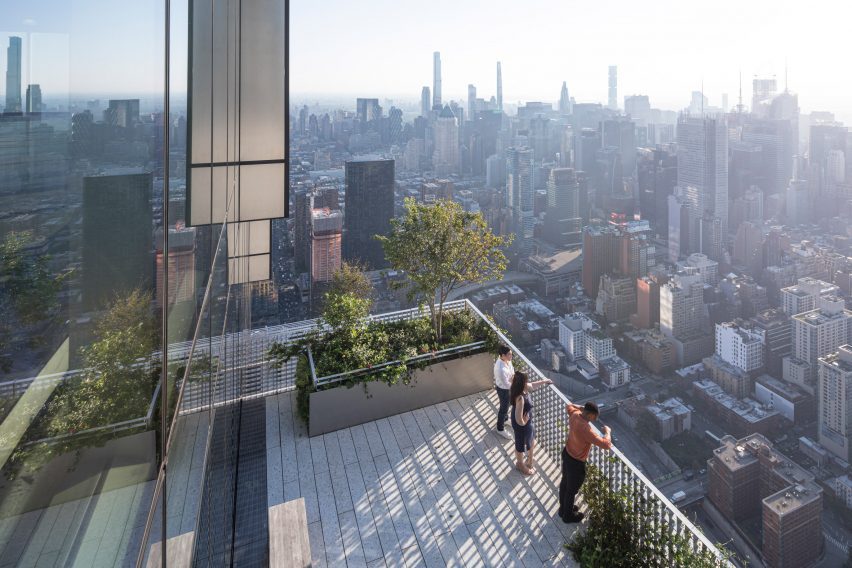 People looking out over NYC on a terrace