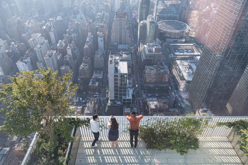 People looking out over NYC on a terrace