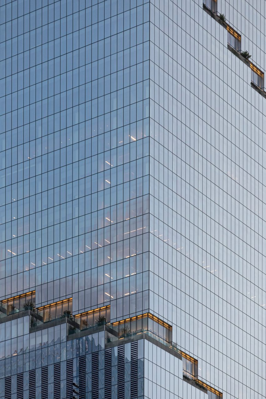 The glass facade of a building with surrounded with stepped terraces