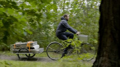 Trunk Bunk portable treehouse by Henry K Wein being towed by bicycle