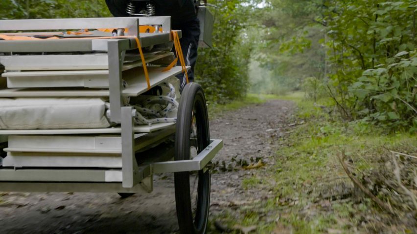 Trunk Bunk portable treehouse by Henry K Wein being towed by bicycle