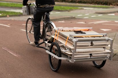 Trunk Bunk portable treehouse by Henry K Wein being towed by bicycle
