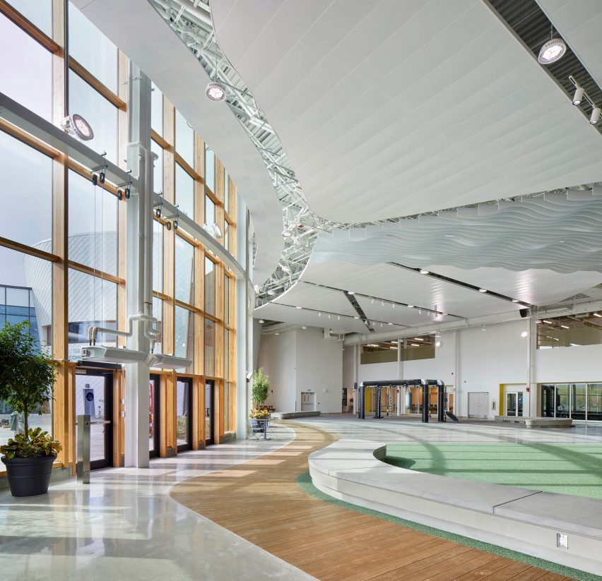 A gymnasium in Canada with a large window and green floor