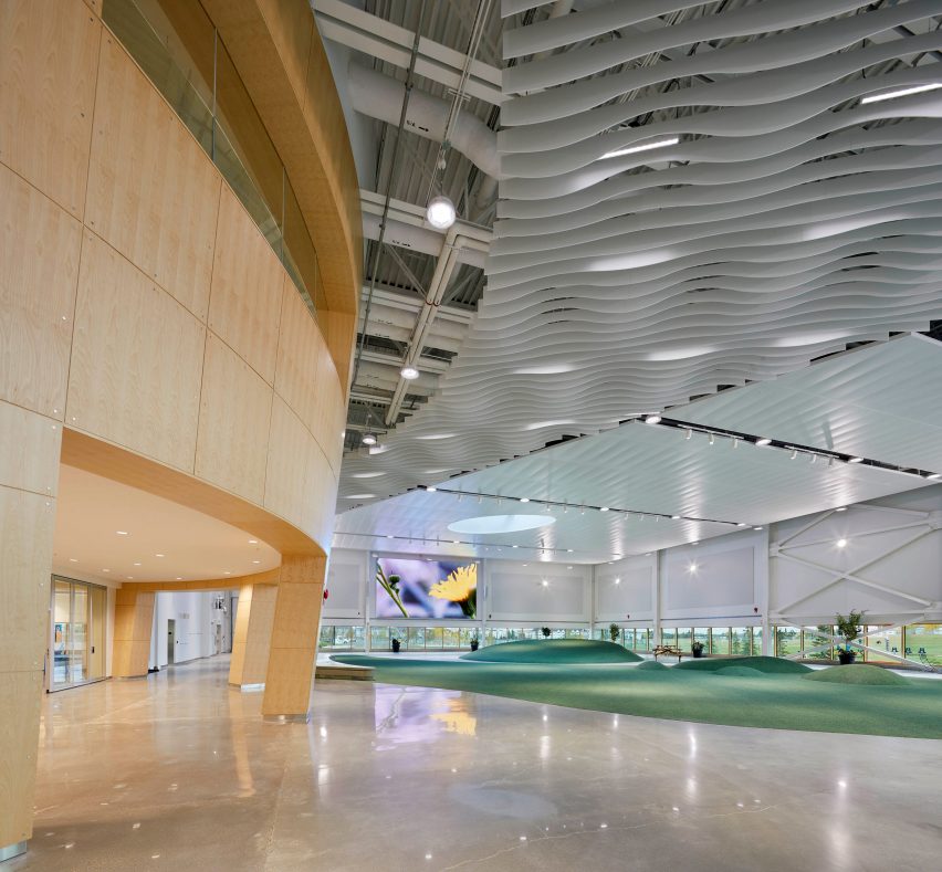 A large wooden unit in a gymnasium with green flooring