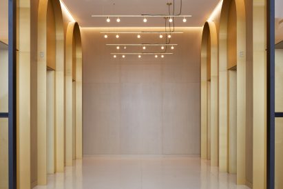 Elevator bank with arches over doorways on either side