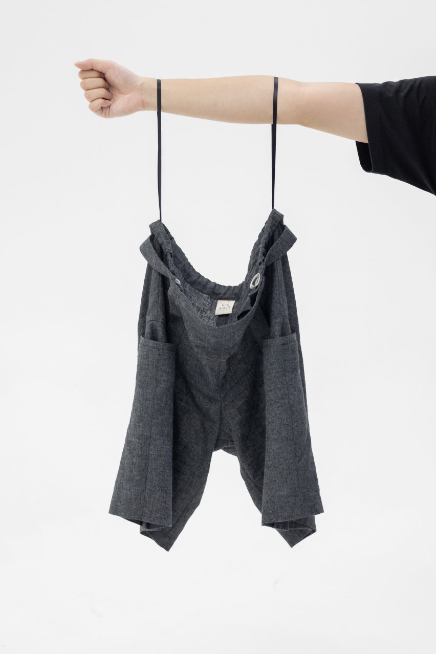 Photo of Will&Well's Adjustable Shorts hanging from a person's arms by the HangLoops on the waistband