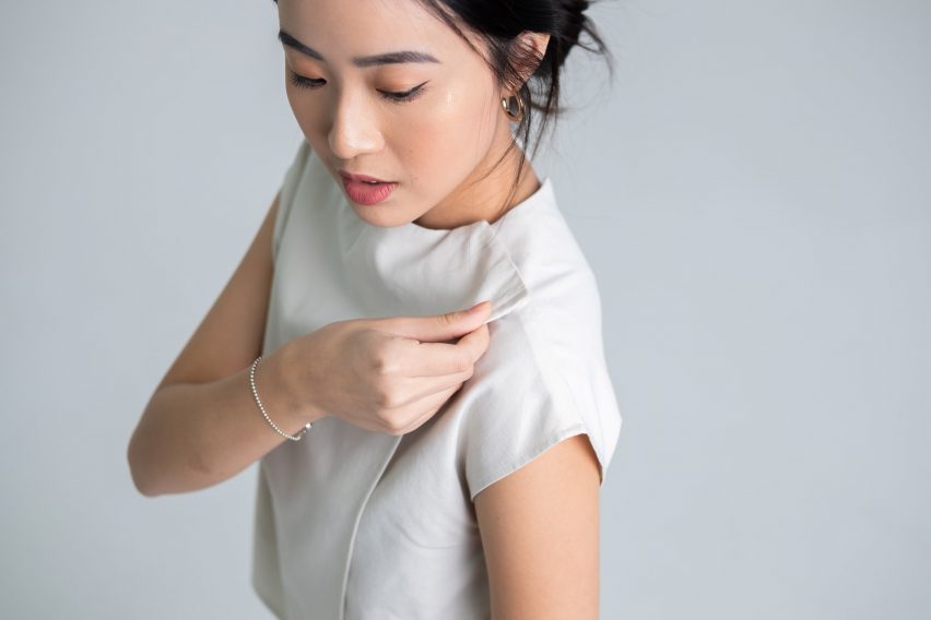 Photo of a model wearing Will&Well's Two-Way blouse, with a close-up of the velcro fastening at the neck line