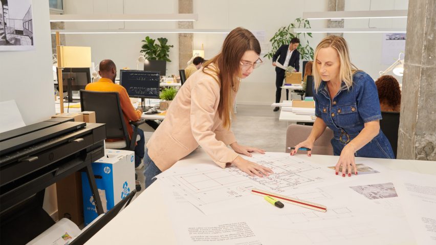 Photo of people in an office with a HP printer
