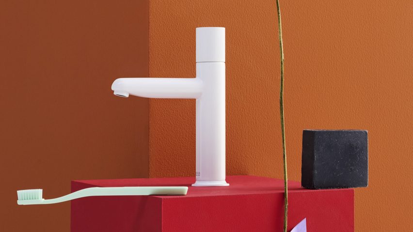 White tap next to toothbrush