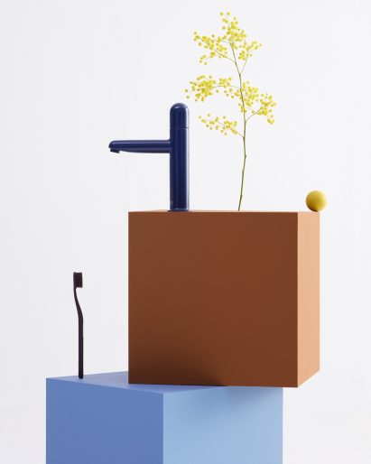 Navy faucet on top of blue and terracotta bricks