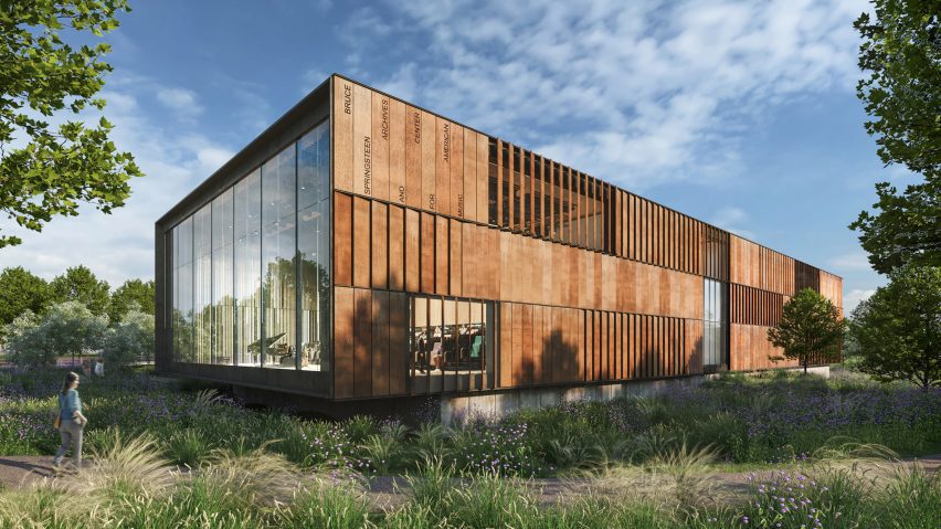 A rectangular metal clad building with glass curtain wall