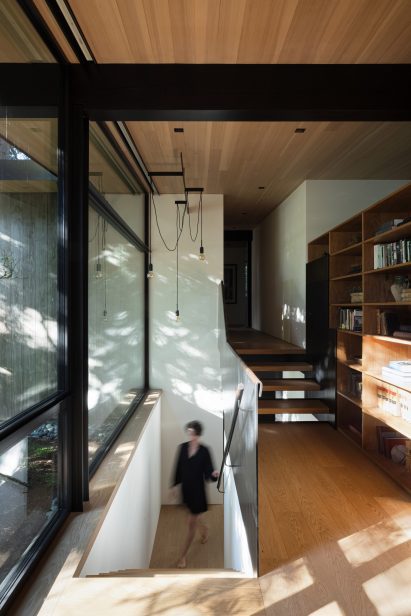 Split-level staircase beside a large bookshelf