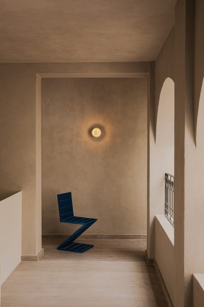 Semi-enclosed loggia with a blue chair