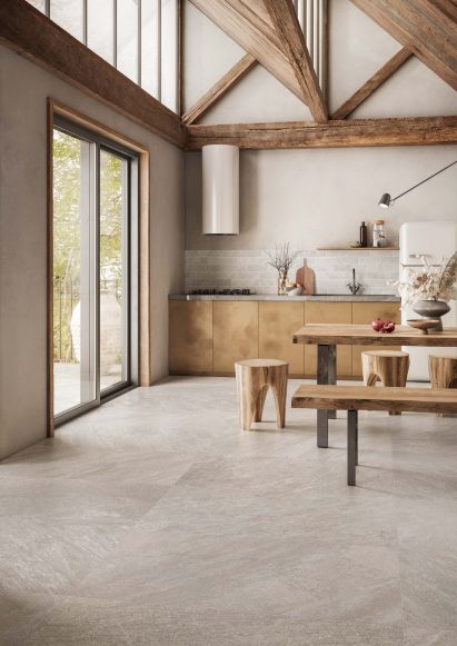 Kitchen with vaulted ceiling and stone slabs on floor