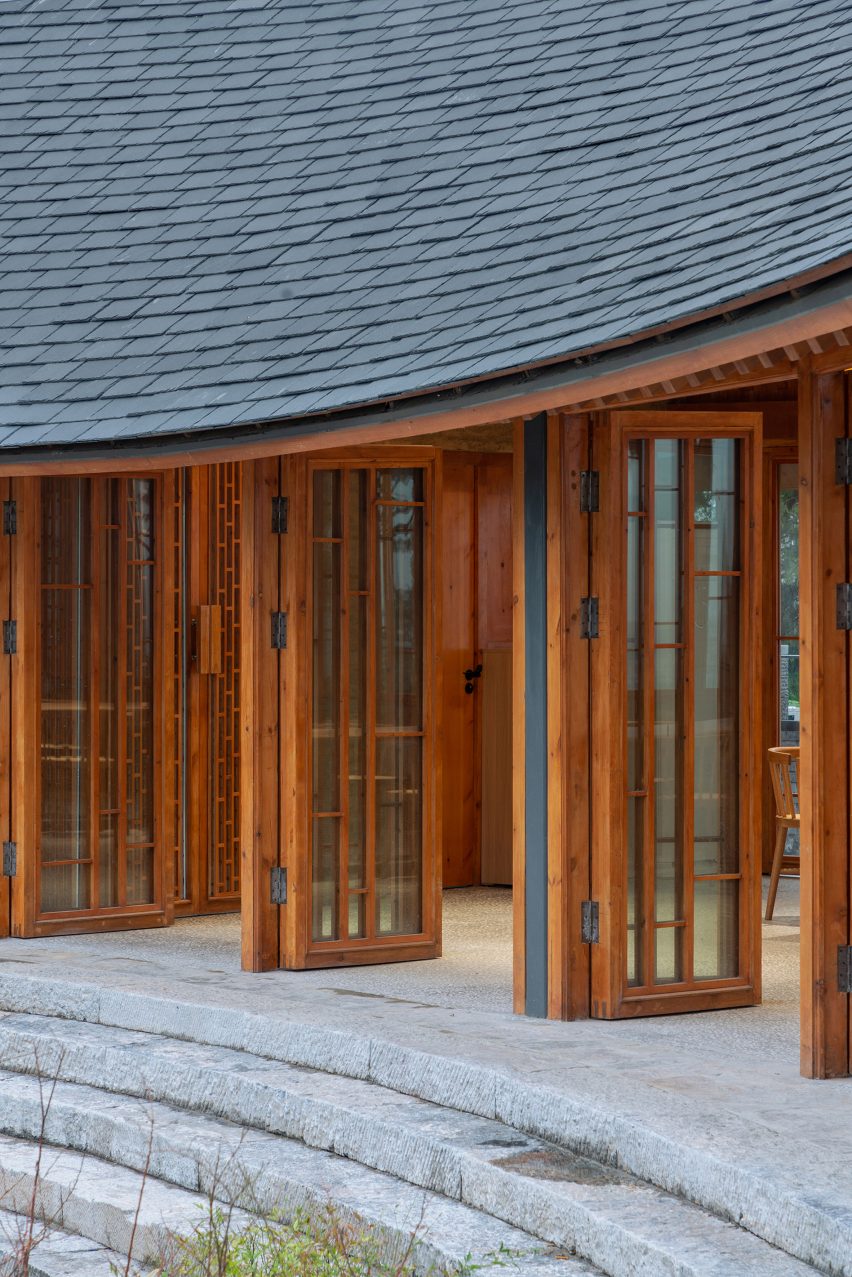 Glass door openings in a curving timber facade
