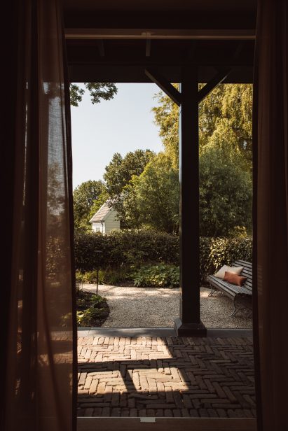 Small gabled outbuilding outside garden annex of De Durgerdam hotel by Aedes 