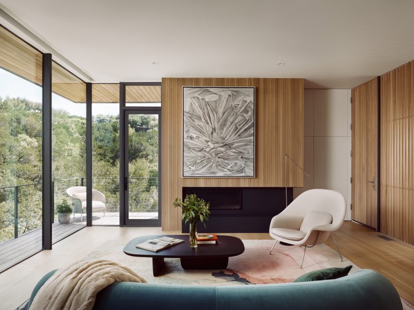 a blue couch in living room with large windows