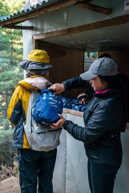 Hikers clip the bags onto their own backpacks