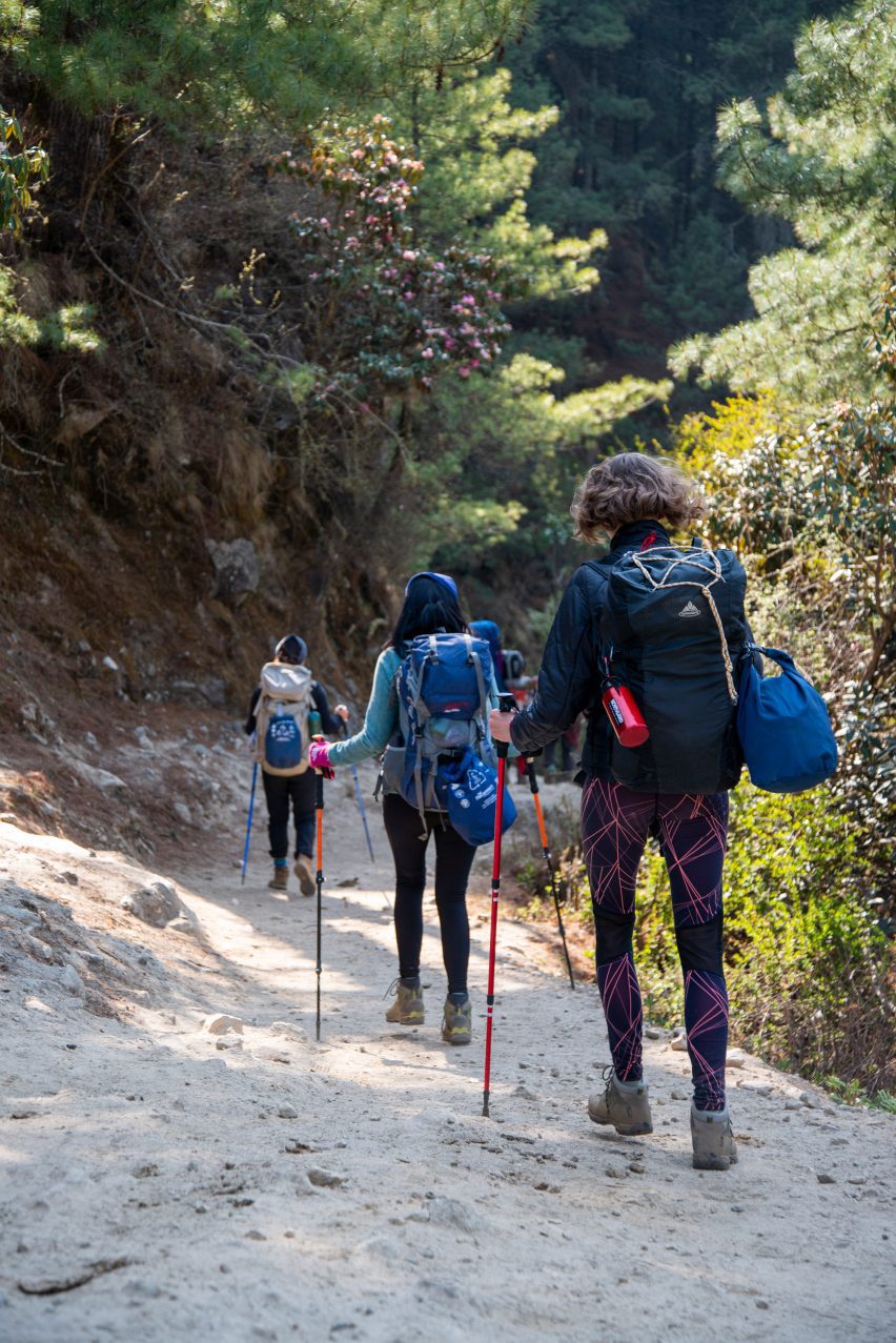 Hikers carry bags of trash in From The Himalayas project by Super Local