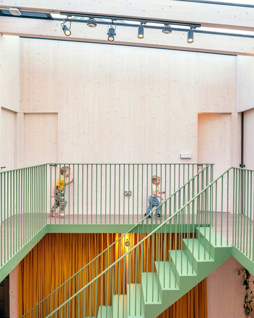 Green-painted stairs and banister at Green House