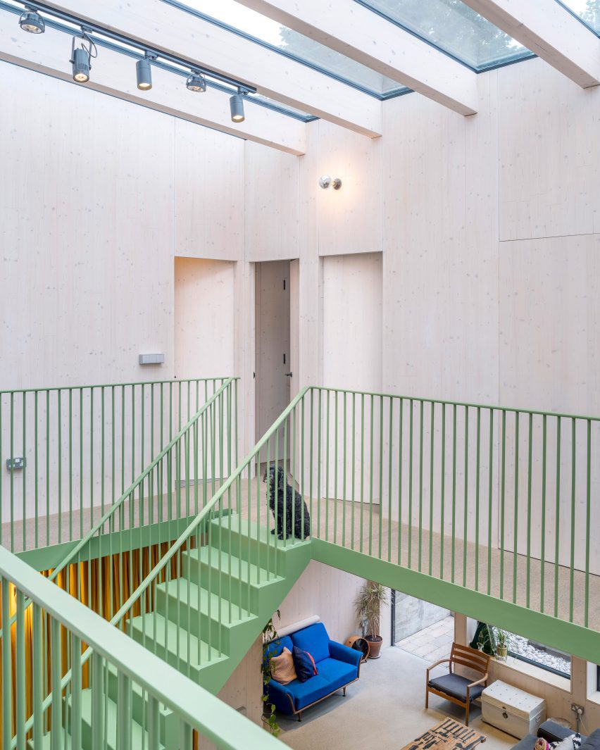 Green-painted metal staircase in an atrium