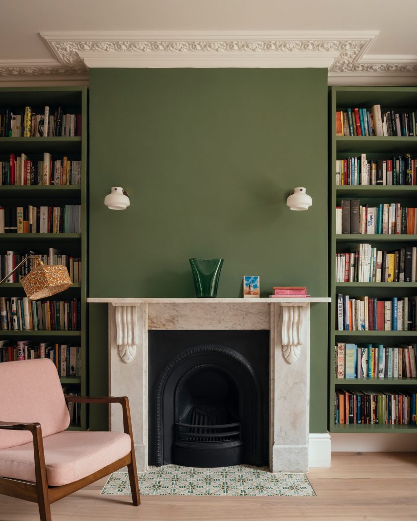 Victorian fireplace with new green walls and bookshelves