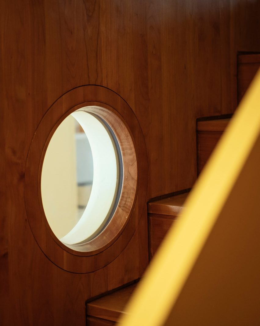 from the stairs a porthole provides light and visual access to room below
