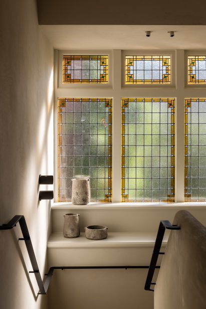 Hallway with stained glass windows inside Haarlem House