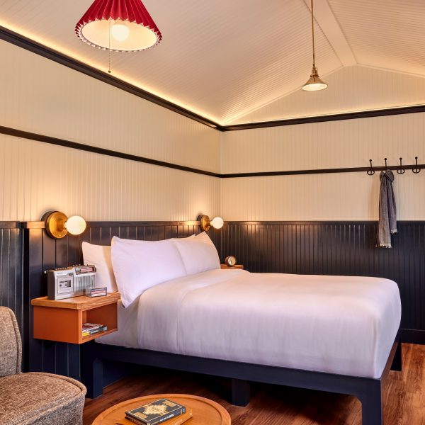 Guest room with double bed, blue wainscoting and white upper walls