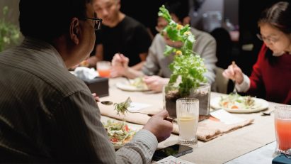 Photograph showing people dining at a table