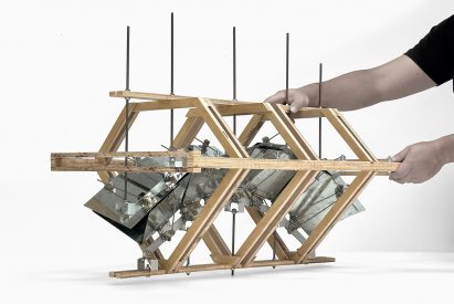 Person handling a wooden frame on white backdrop