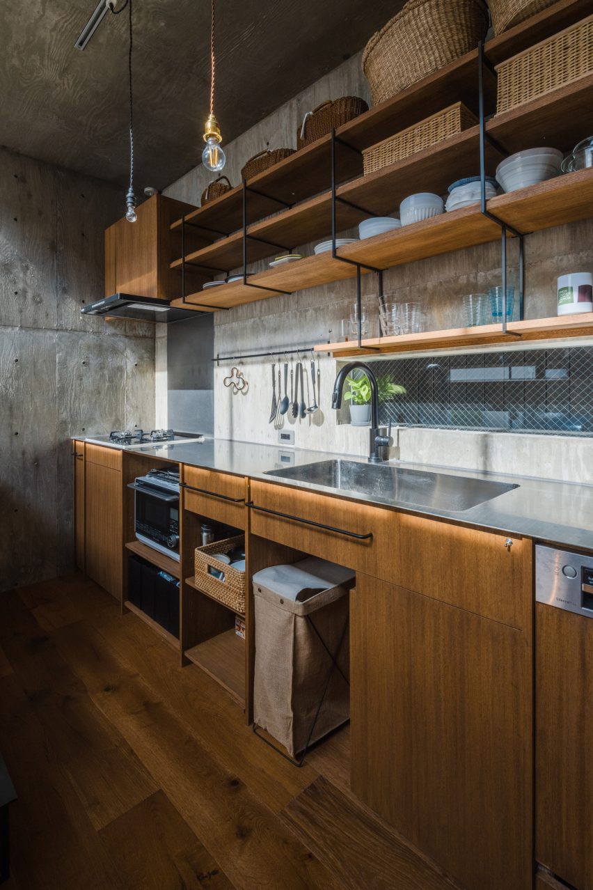 Kitchen with wood units in a concrete home