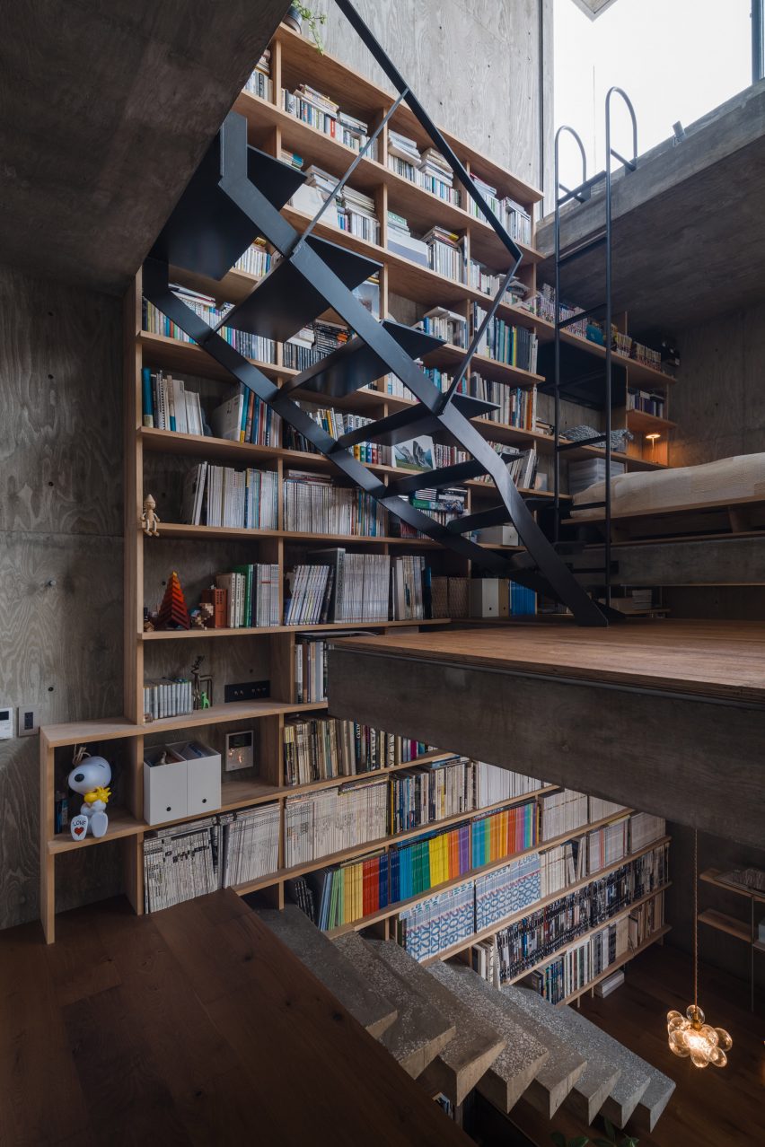 Two staircases spanning across a bookshelf wall