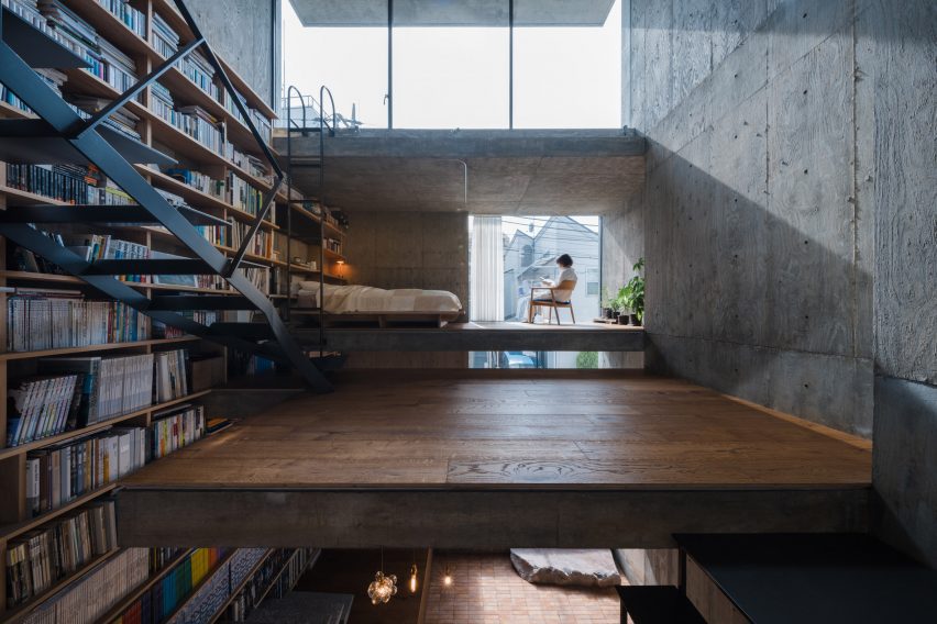Concrete home interior in Japan with a bookshelf wall
