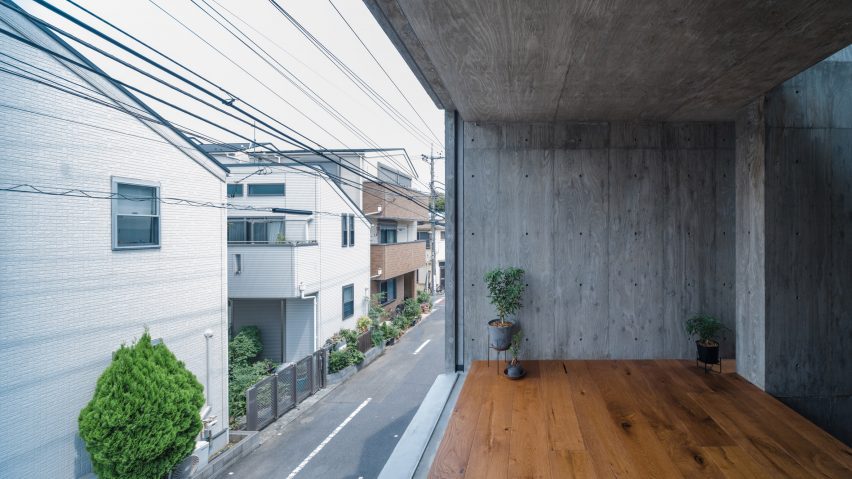 Floor-to-ceiling window in a concrete home overlooking a street