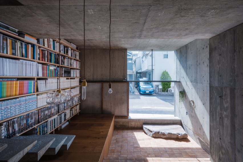 Concrete home interior with a bookshelf wall