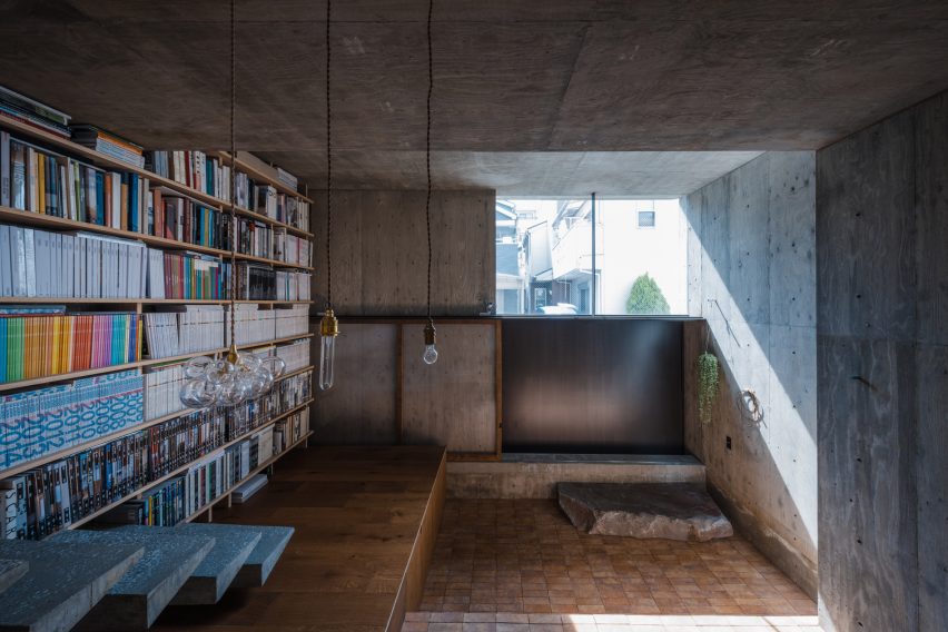 Concrete home interior with a bookshelf wall