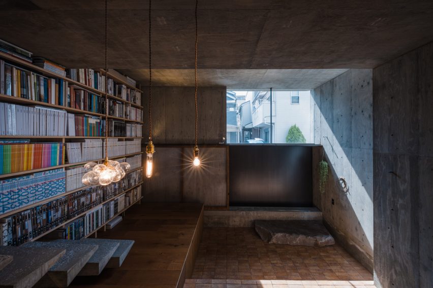 Concrete home interior with a bookshelf wall