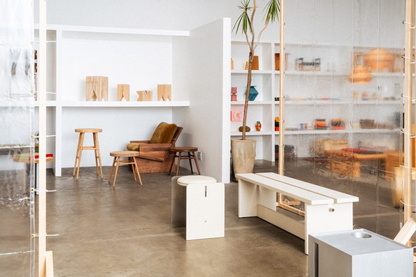 A showroom with white shelves populated with design objects