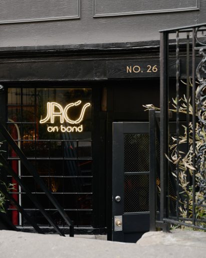 Exterior of Jac's on Bond with a sign in the window