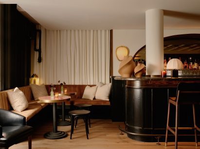 Seating niche with small tables beside bar counter