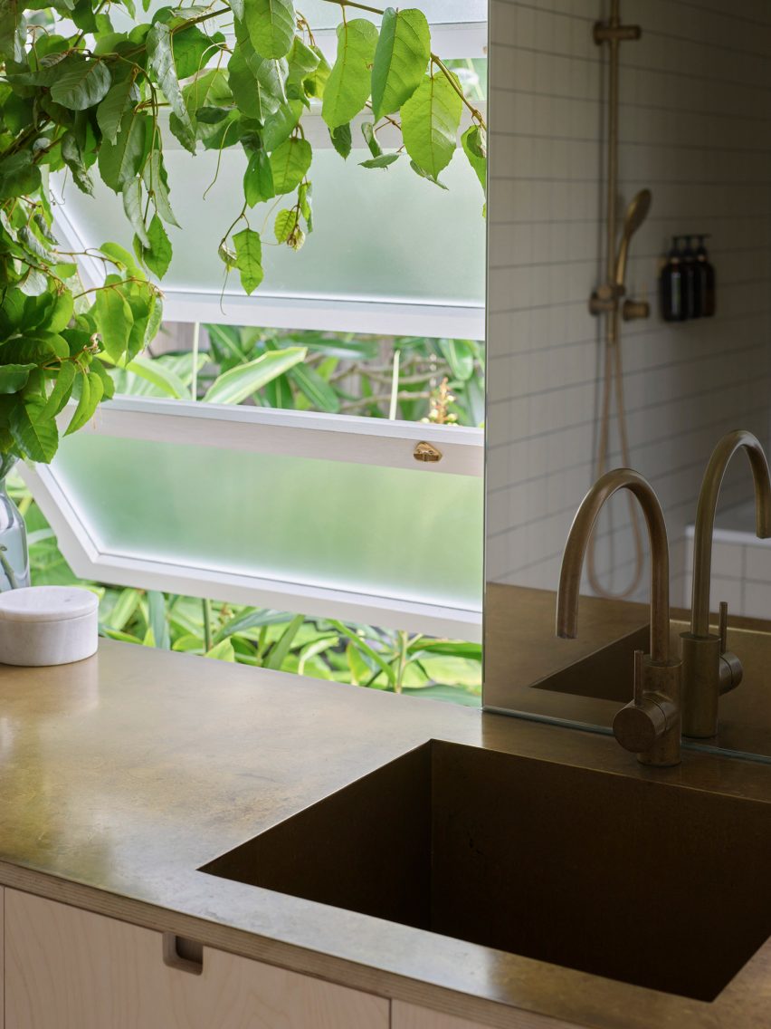 Kitchen sink next to open frosted windows