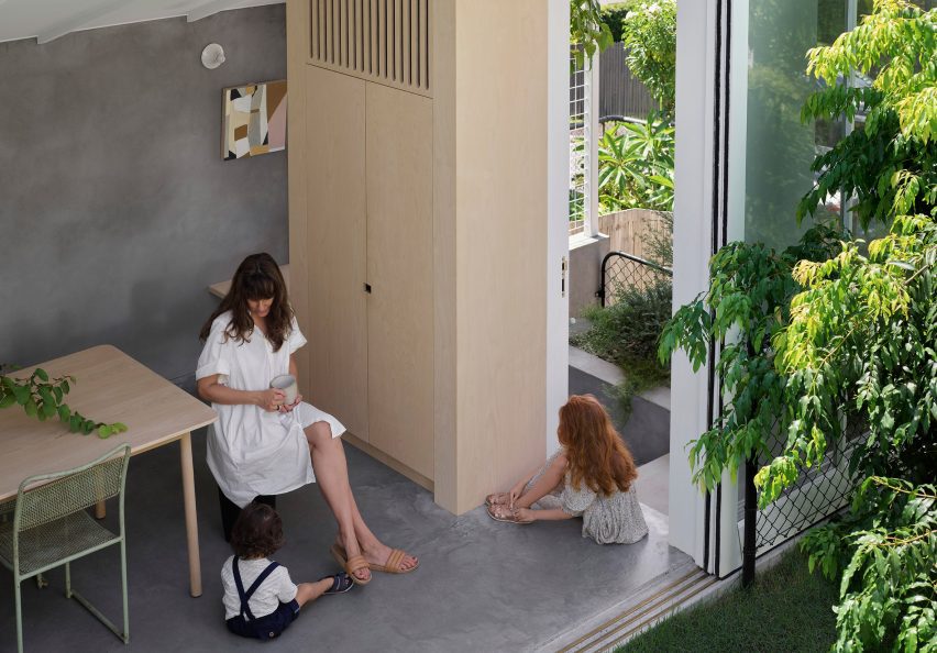 Mother and daughter sitting in the concrete interior at Cascade House