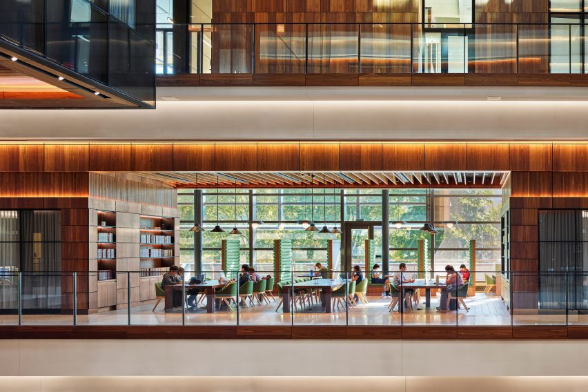 People eating at a cafe in a space with a large atrium
