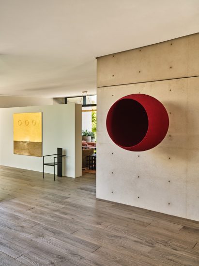 Artworks displayed on concrete and white walls