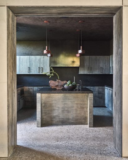 Kitchen with a central island and dark cabinetry