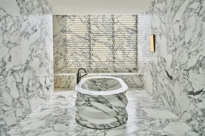 Bathroom lined entirely in dramatic black and white marble