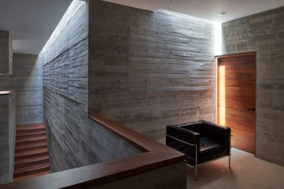 Raw, grey concrete interior of house by Lucio Muniain