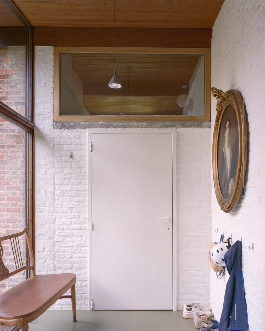 Corridor with white brick walls and timber-framed windows